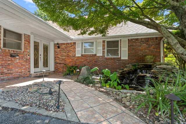 a front view of a house with garden