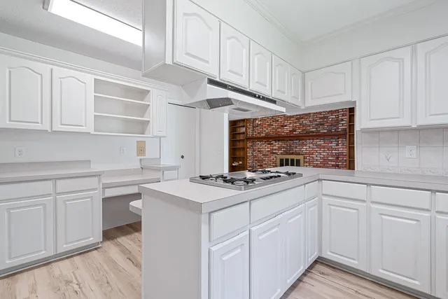 a kitchen with cabinets and appliances
