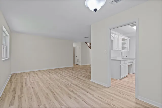 a bedroom with a beds and a chandelier