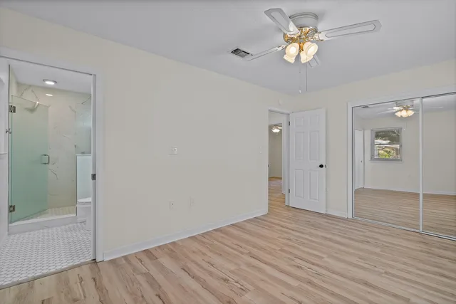 a bathroom with a granite countertop sink a toilet and shower