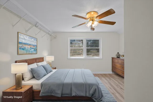 a living room with furniture wooden floor and a large window