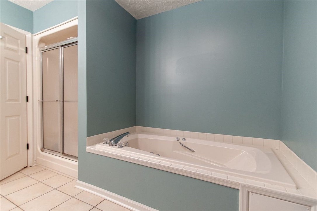 1328 Owens Road Auburn, AL 36830 - Photo 14 of 22 Primary bathroom tub and shower area.