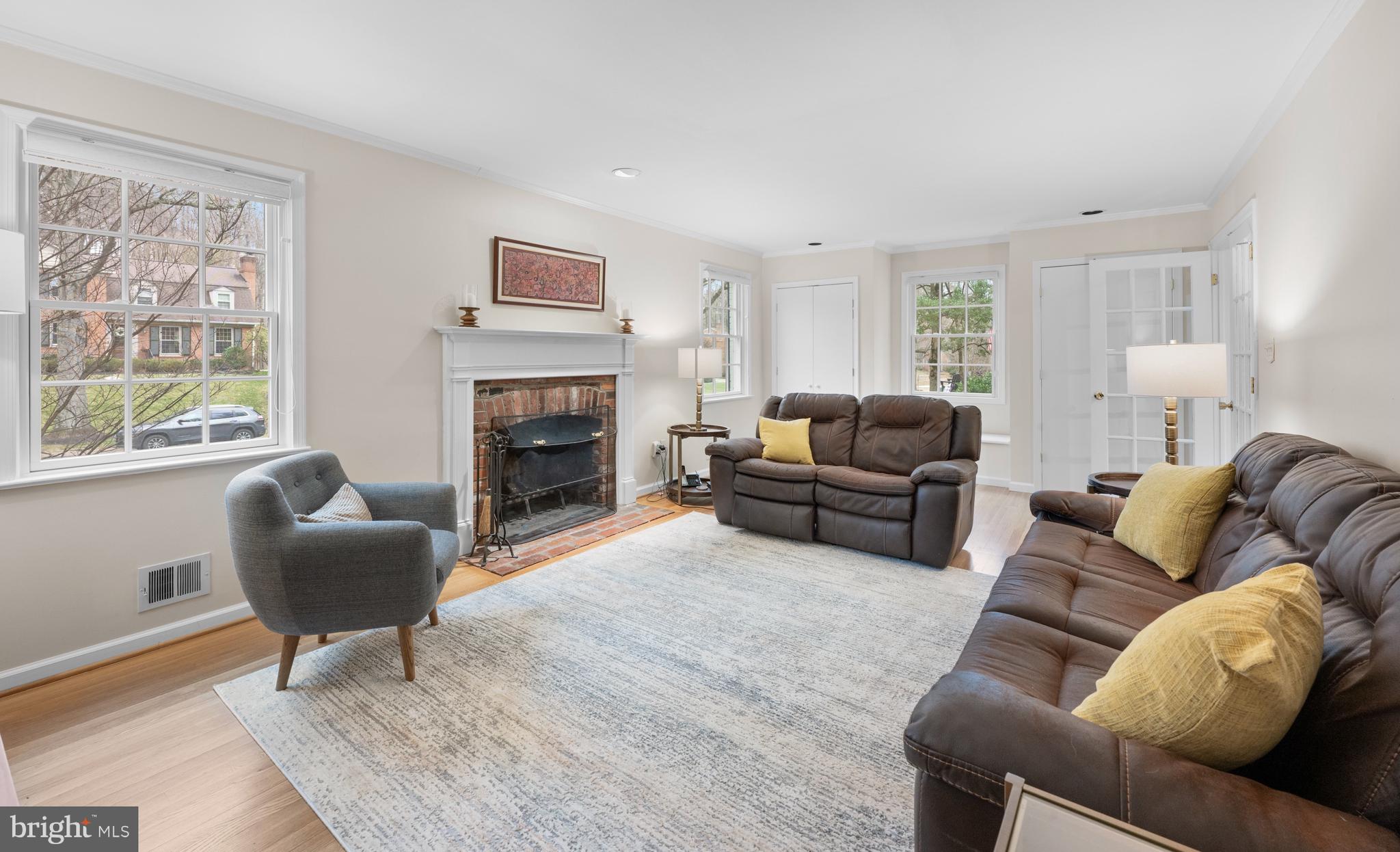 7708 Hackamore Drive Potomac, MD 20854 - Photo 12 of 34 a living room with furniture a fireplace and a large window
