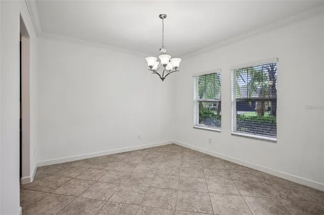 a view of a chandelier in big room and chandelier
