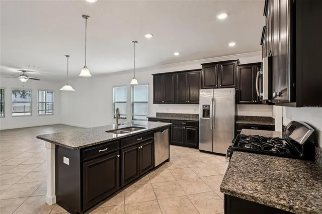 a kitchen with a stove a refrigerator and a sink