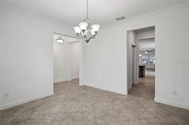 a view of an empty room with a chandelier