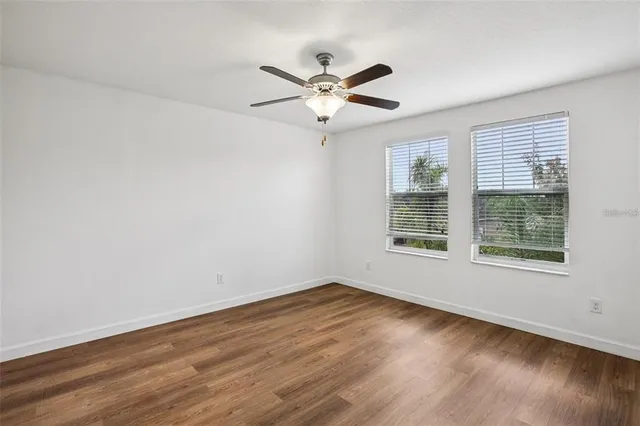 wooden floor in an empty room with a window