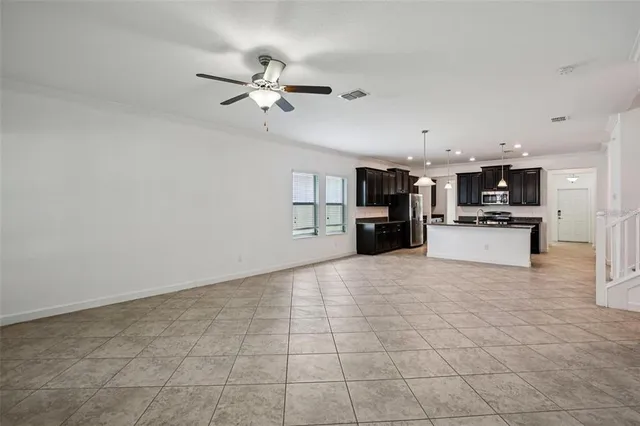 a view of a kitchen with a sink and a refrigerator