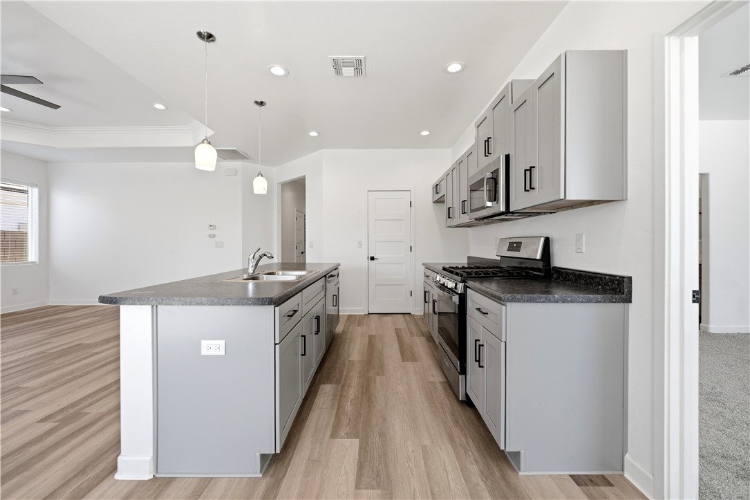 3546 North Skylark Road Kingman, AZ 86409 - Photo 5 of 30 a kitchen with stainless steel appliances granite countertop a sink and a stove top oven