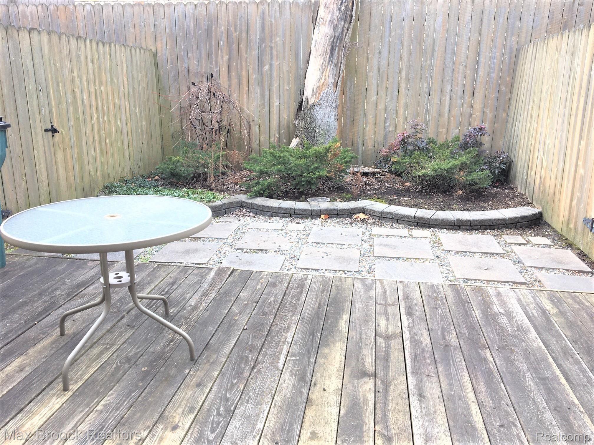 1472 West Webster Road, Unit 10 Royal Oak, MI 48073 - Photo 14 of 14 Large deck out back with a privacy fence around. Small garden area as well for spring flowers!