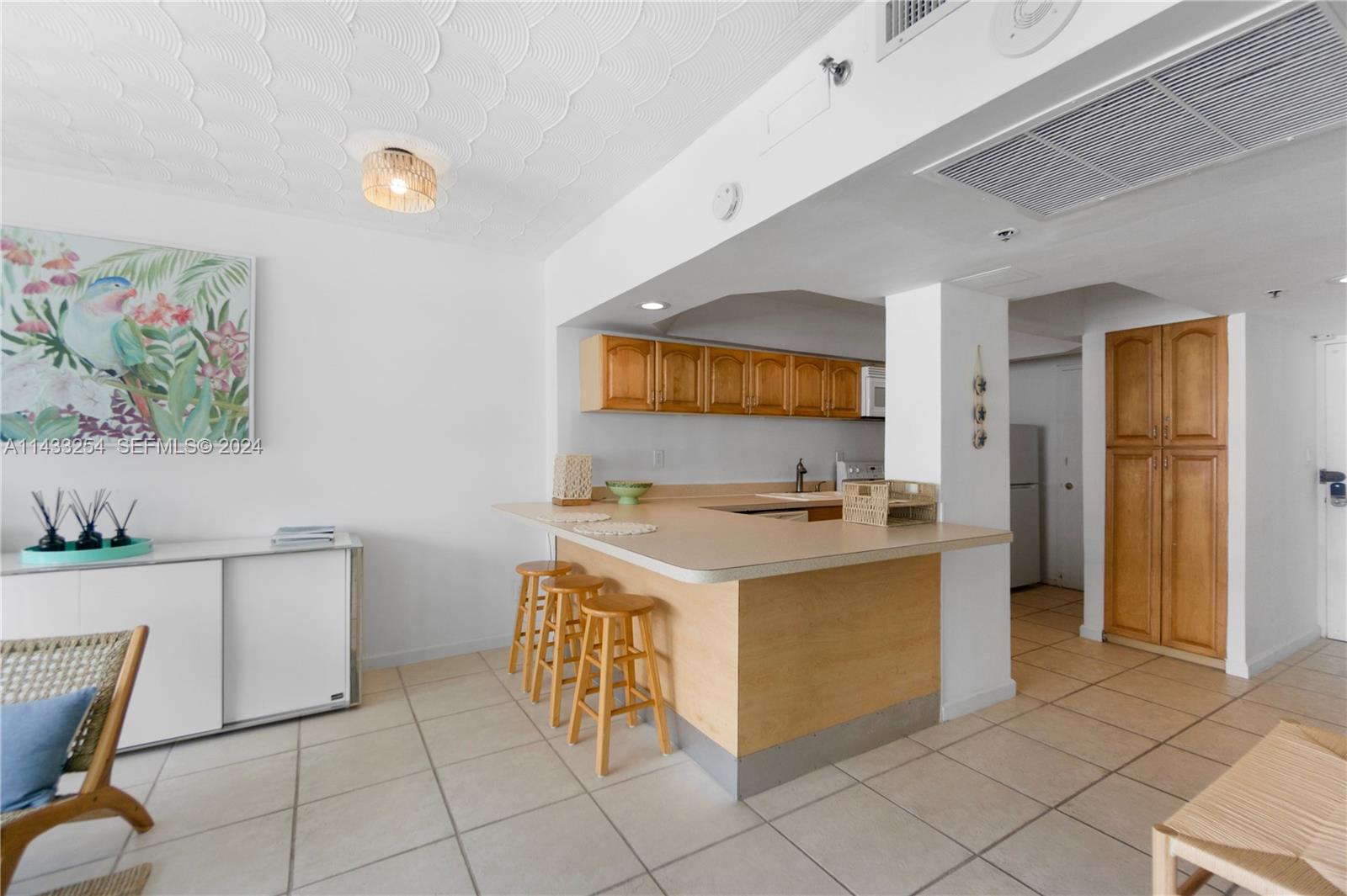 100 Lincoln Road, Unit 1039 Miami Beach, FL 33139 - Photo 9 of 26 a kitchen with a stove and a refrigerator