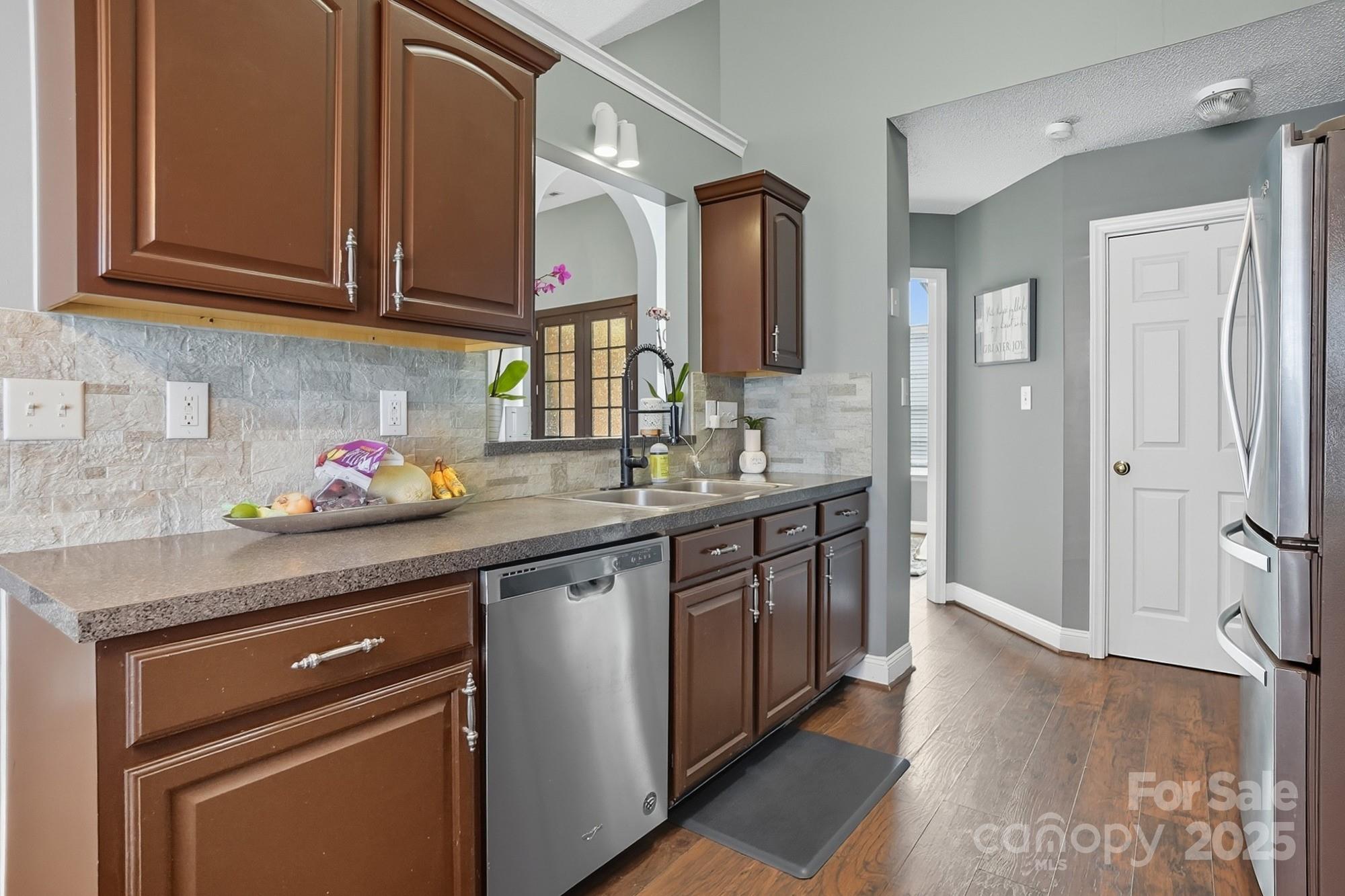 12639 Hill Pine Road Midland, NC 28107 - Photo 14 of 45 a kitchen with stainless steel appliances granite countertop a sink stove and cabinets