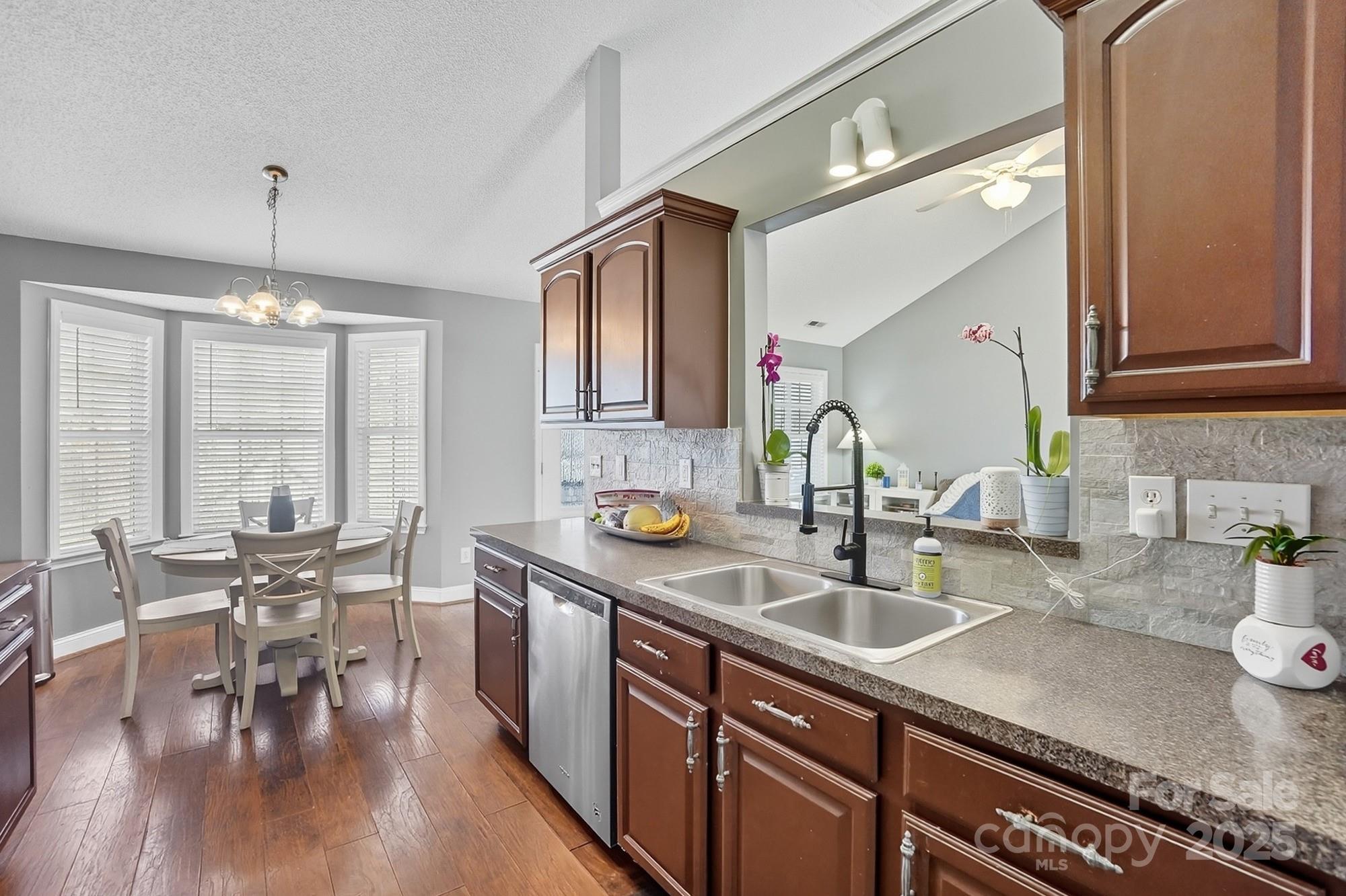 12639 Hill Pine Road Midland, NC 28107 - Photo 16 of 45 a kitchen with sink cabinets and wooden floor