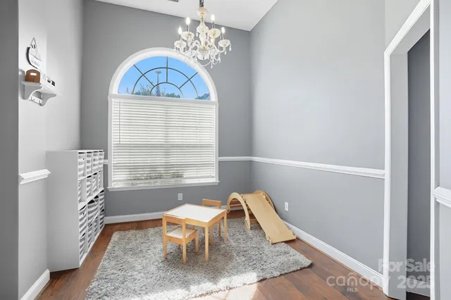 a view of a dining room with furniture and a chandelier