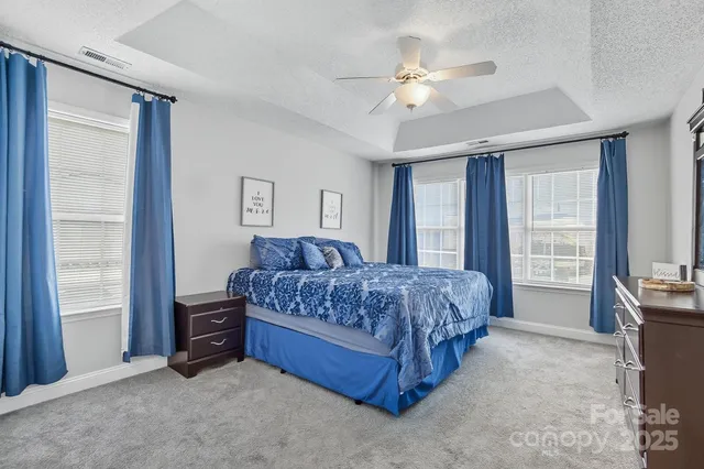 a bedroom with a bed dresser and a window