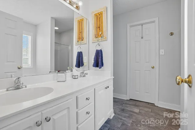 a bathroom with a double vanity sink and mirror