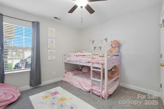 a bed room with a bed and a baby bed