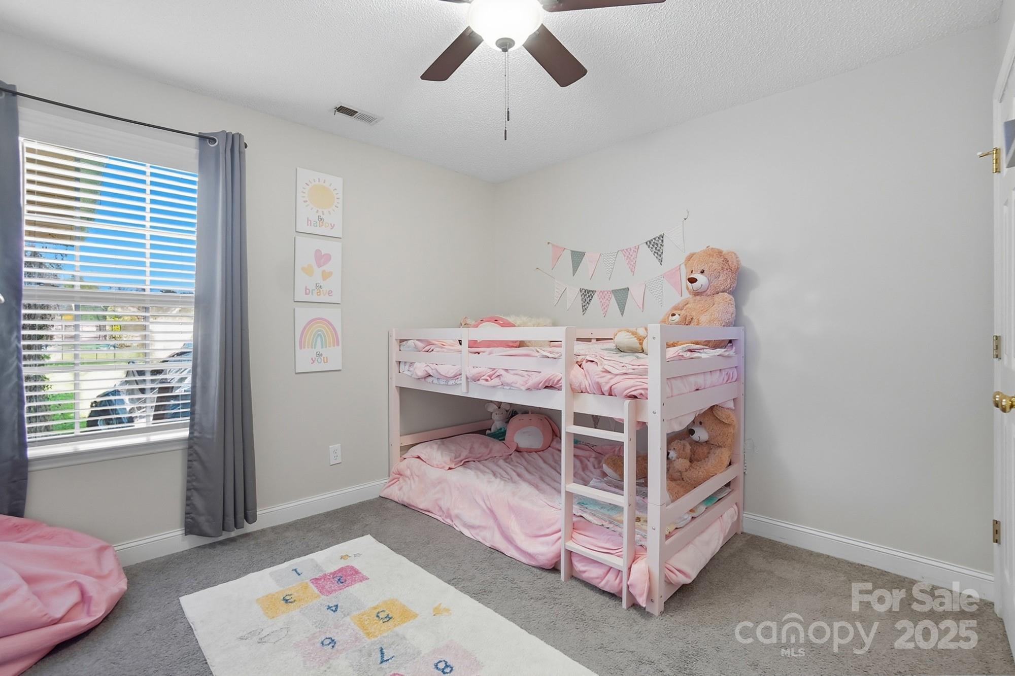 12639 Hill Pine Road Midland, NC 28107 - Photo 29 of 45 a bed room with a bed and a baby bed
