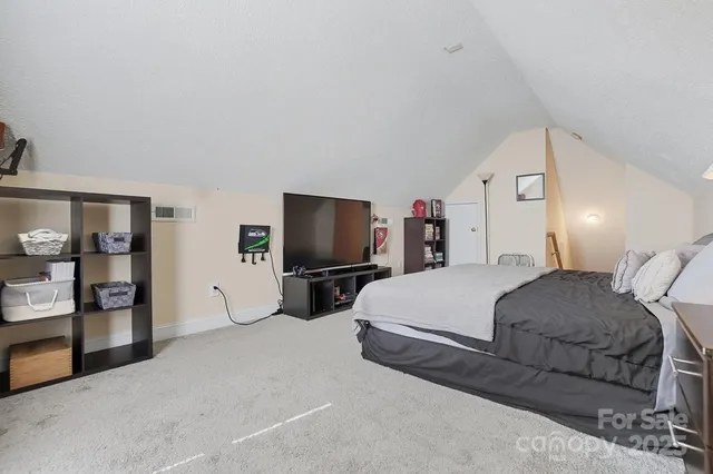 a bedroom with a bed and a television in it