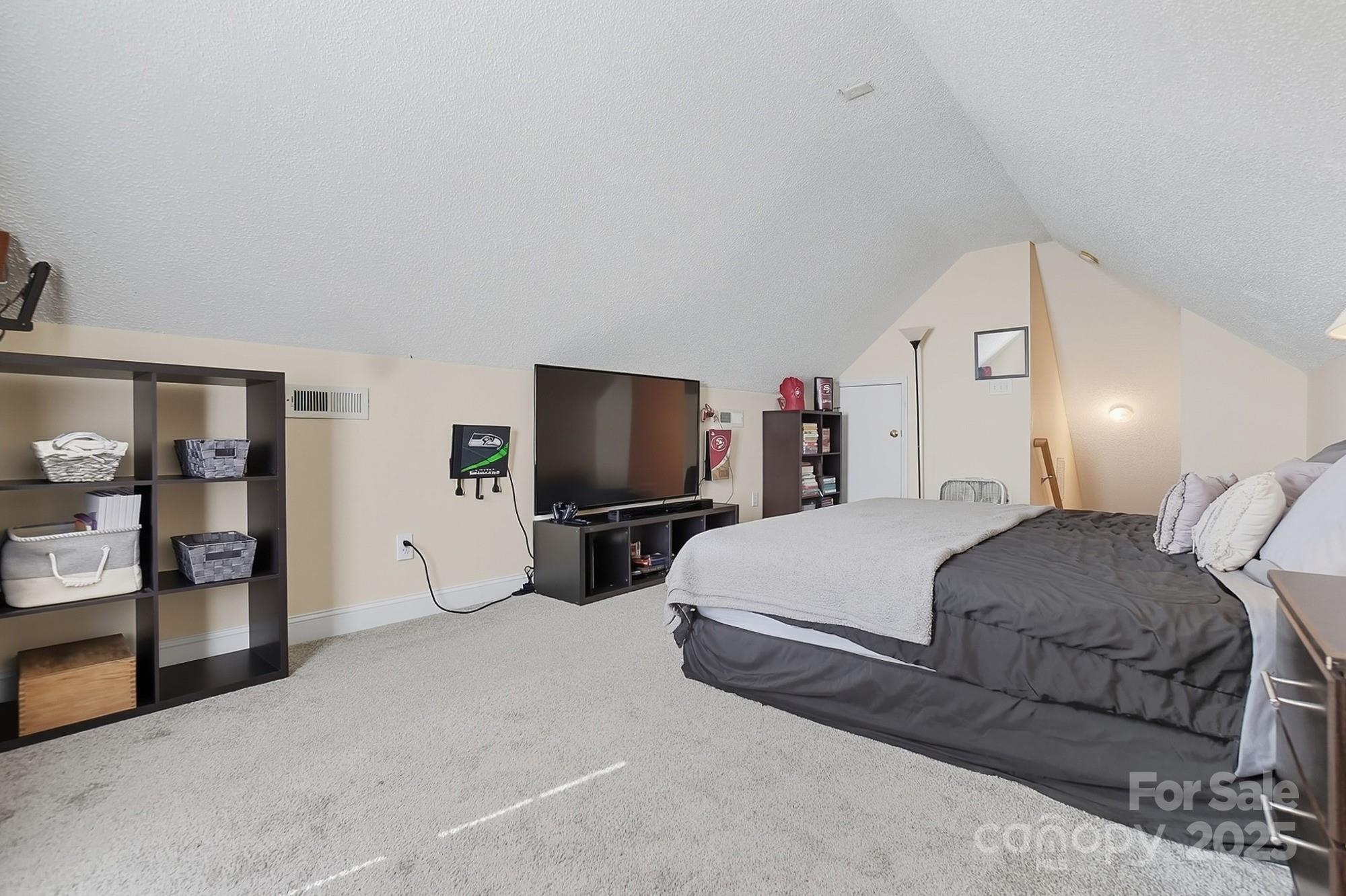 12639 Hill Pine Road Midland, NC 28107 - Photo 37 of 45 a bedroom with a bed and a television in it