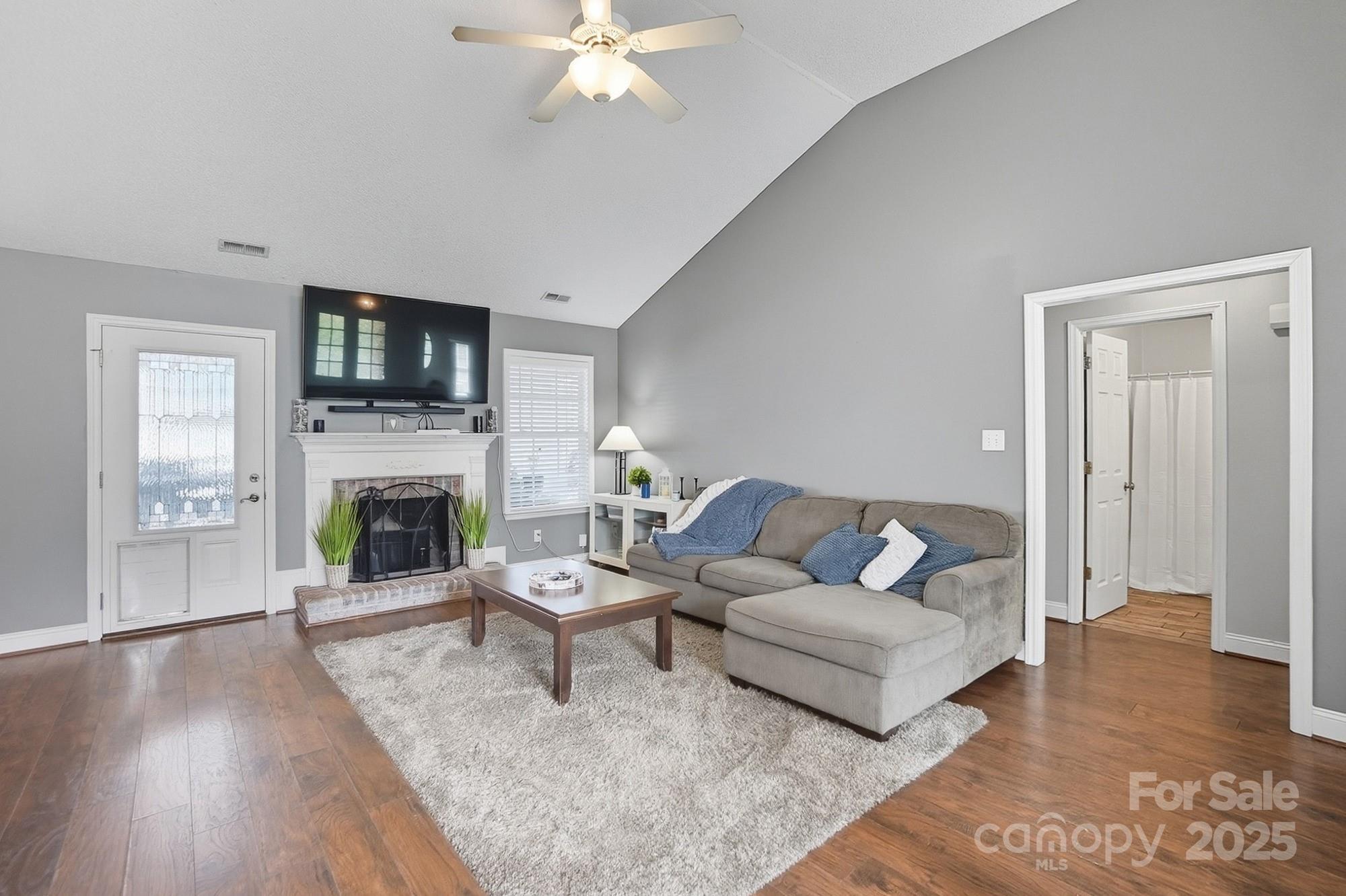 12639 Hill Pine Road Midland, NC 28107 - Photo 6 of 45 a living room with furniture a fireplace and a flat screen tv