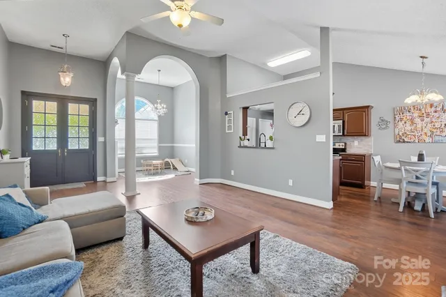 a living room with furniture and wooden floor