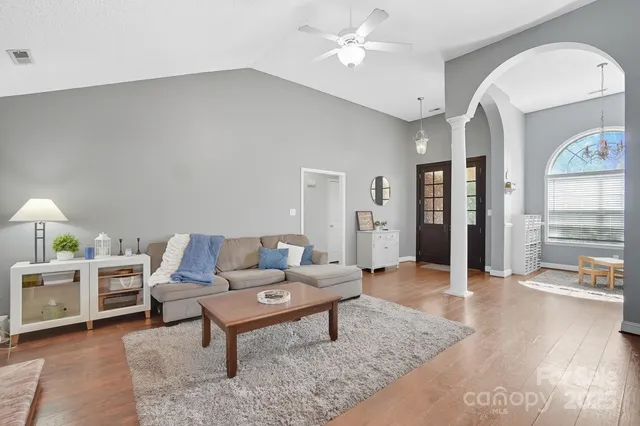 a living room with furniture and wooden floor