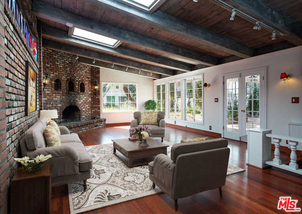 14842 Morrison Street Sherman Oaks, CA 91403 - Photo 1 of 41 a living room with fireplace furniture and a large window