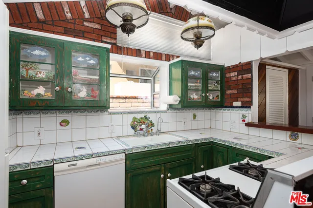 a kitchen with a sink stove and cabinets