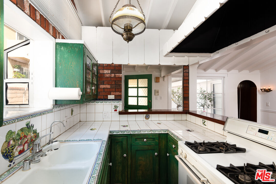 14842 Morrison Street Sherman Oaks, CA 91403 - Photo 15 of 41 a kitchen with a sink stove and cabinets
