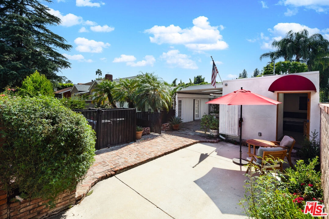 14842 Morrison Street Sherman Oaks, CA 91403 - Photo 18 of 41 a view of a patio with table and chairs potted plants
