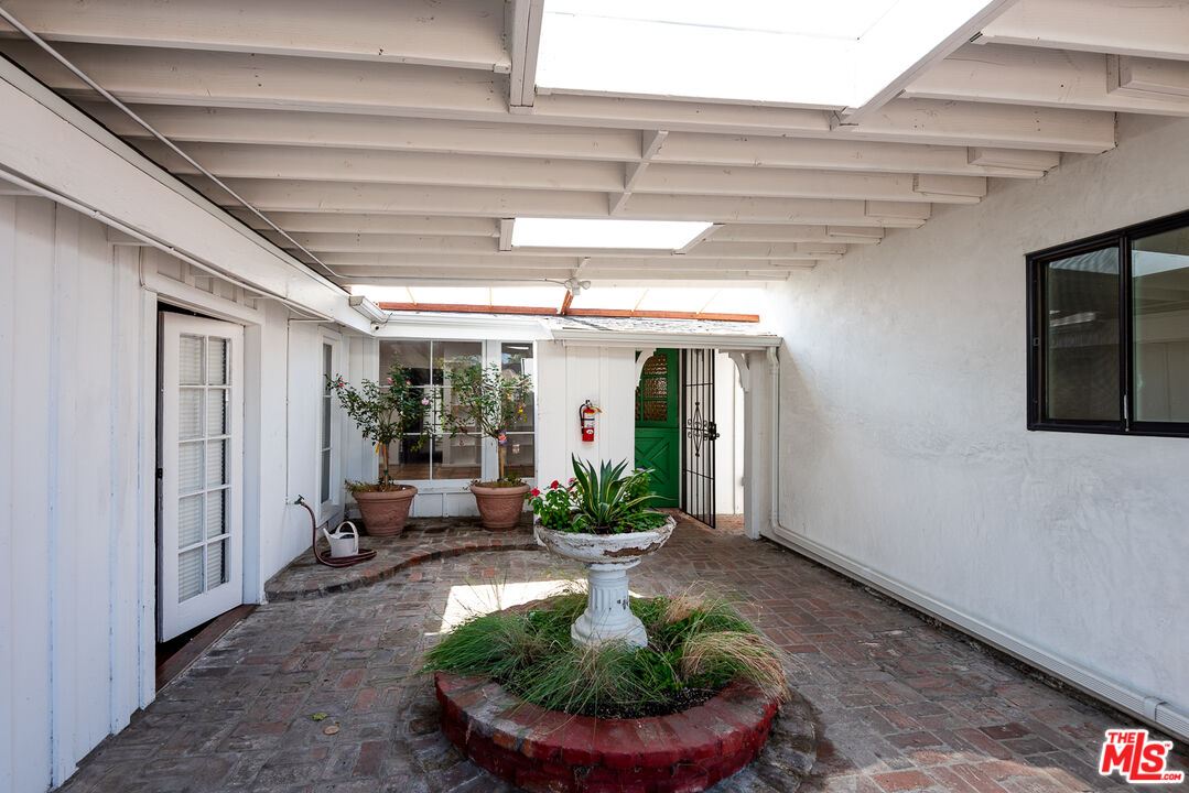 14842 Morrison Street Sherman Oaks, CA 91403 - Photo 19 of 41 a view of a patio with table and chairs potted plants