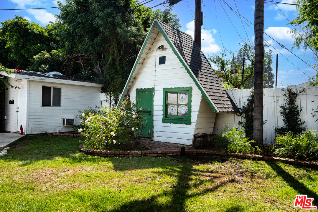 14842 Morrison Street Sherman Oaks, CA 91403 - Photo 22 of 41 a front view of a house with a yard