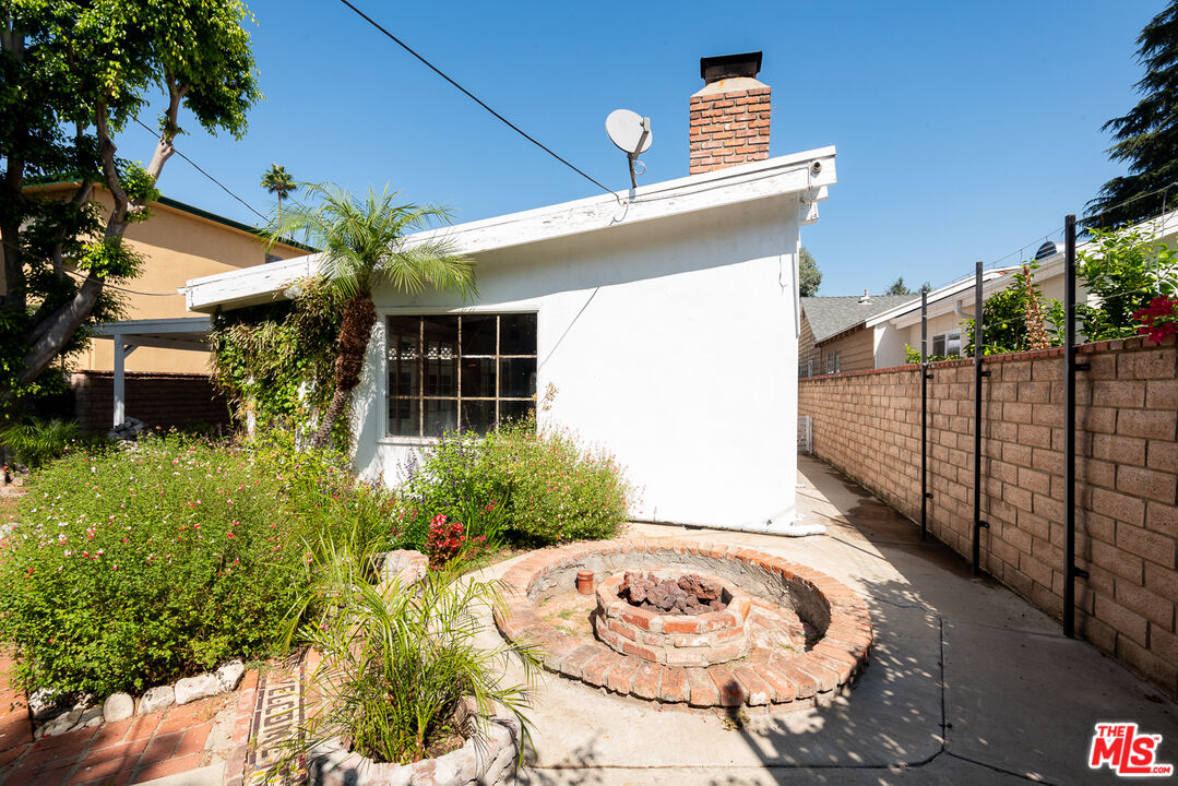 14842 Morrison Street Sherman Oaks, CA 91403 - Photo 25 of 41 a view of a house with a small yard and potted plants