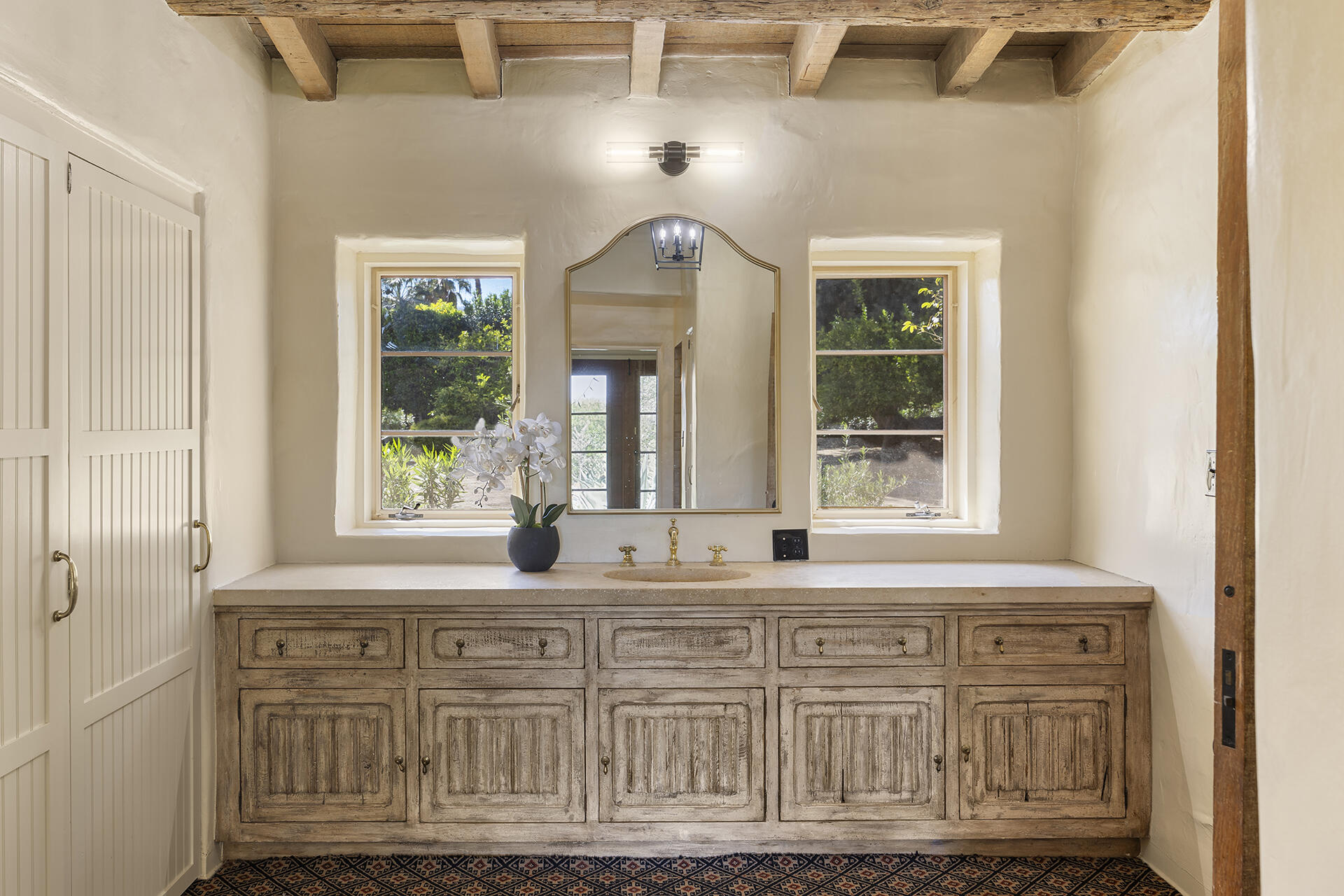 71845 Sahara Road Rancho Mirage, CA 92270 - Photo 17 of 27 a bathroom with granite countertop a sink a large mirror and a window