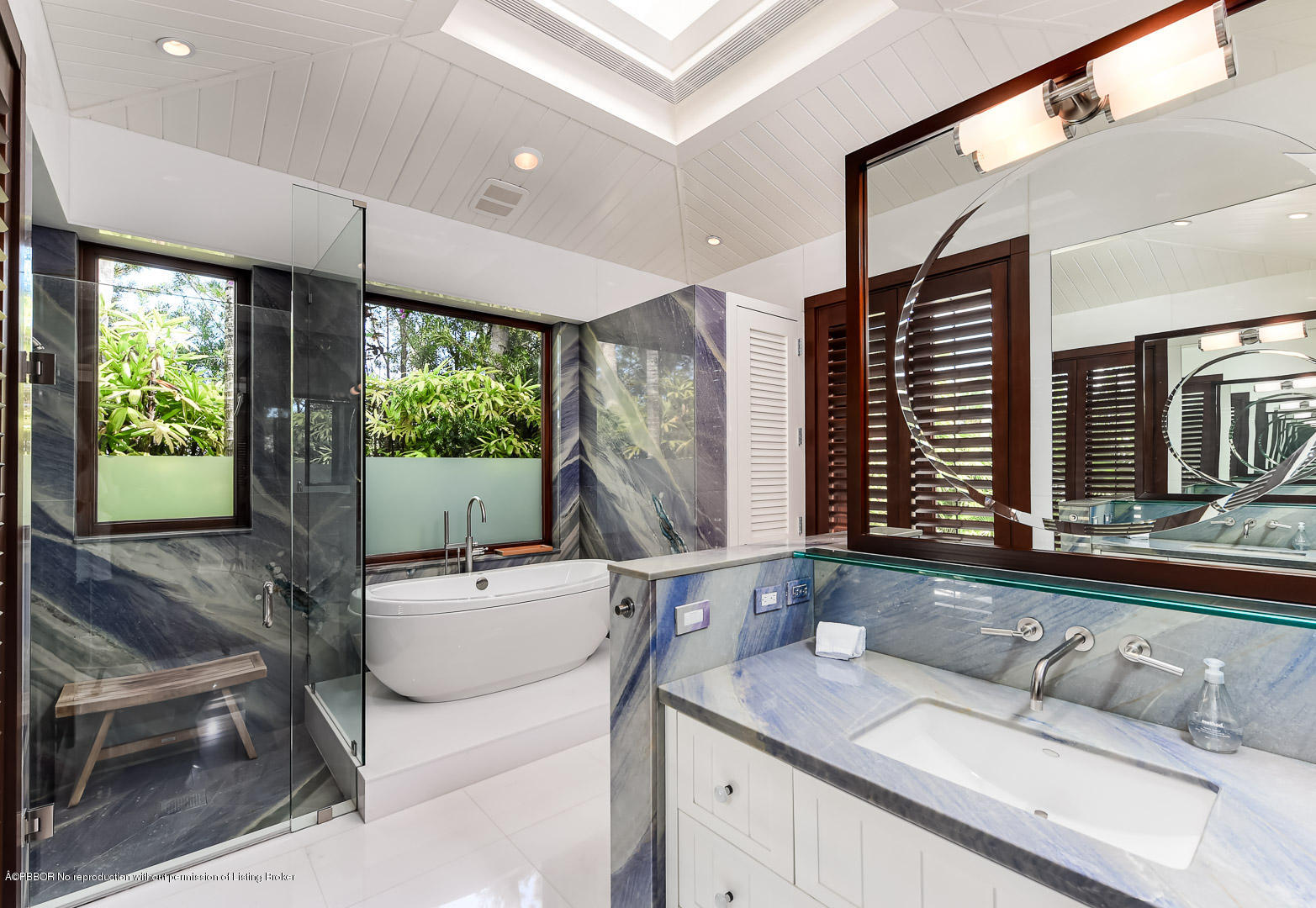 309 Garden Road Palm Beach, FL 33480 - Photo 15 of 26 a bathroom with a double vanity sink a mirror and a bathtub
