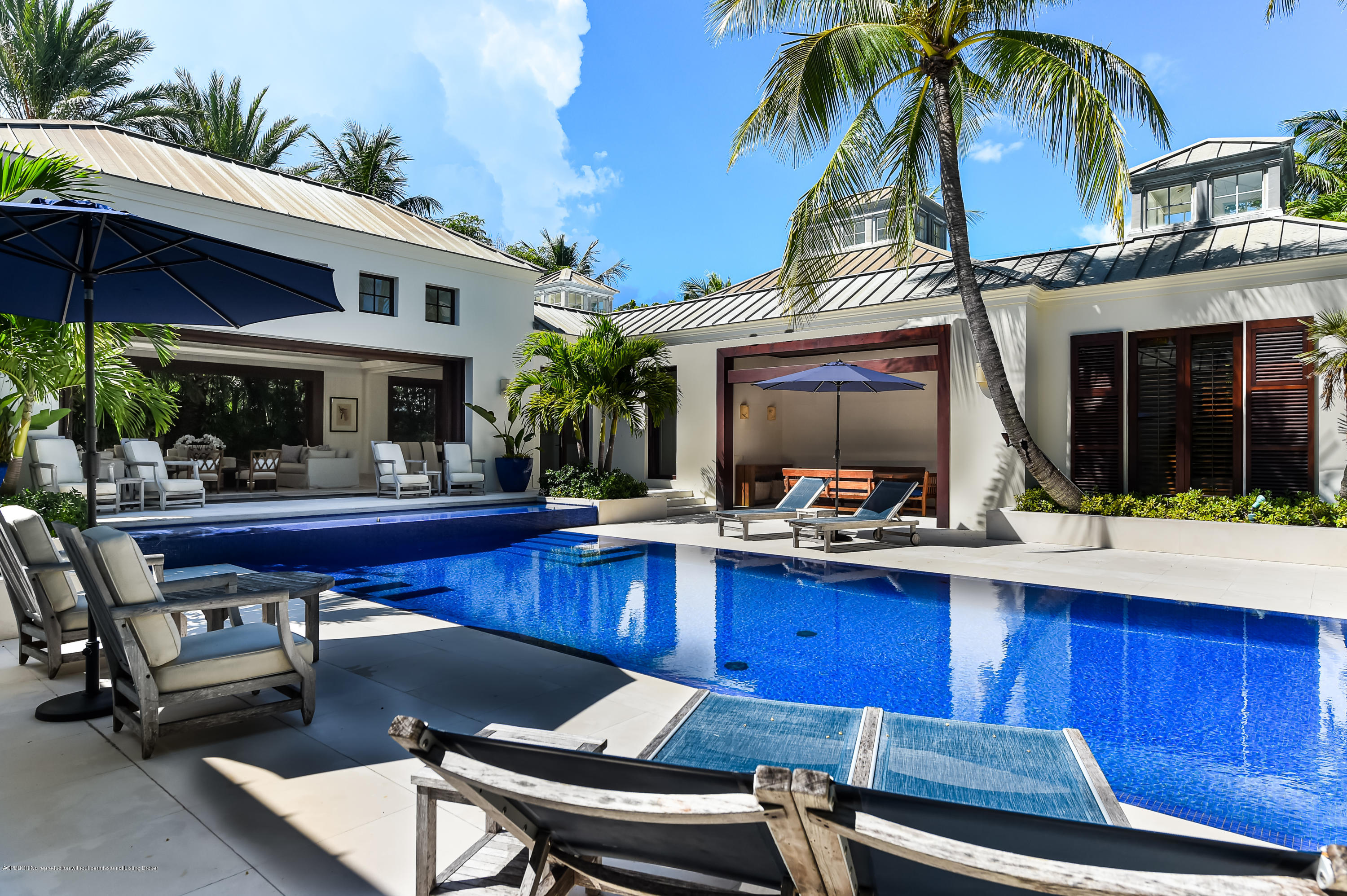309 Garden Road Palm Beach, FL 33480 - Photo 19 of 26 a view of a patio with table and chairs under an umbrella with a barbeque grill and potted plants