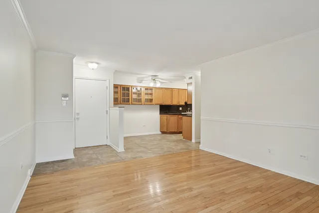 a view of a kitchen with wooden floor and a kitchen