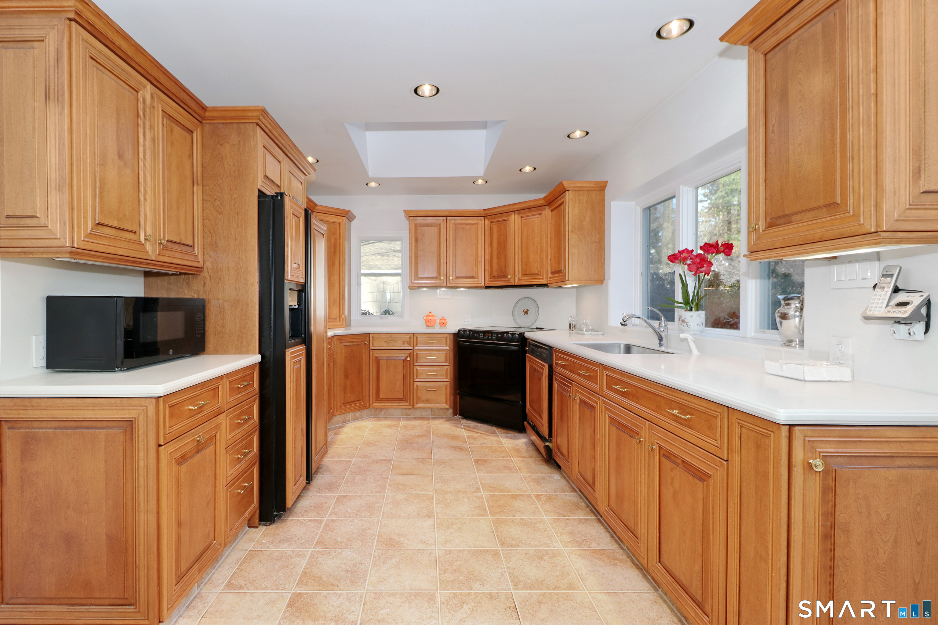 5 Over Rock Lane Westport, CT 06880 - Photo 11 of 28 Light filled custom kitchen boasts two skylights, tile floor and wood paneled appliances.