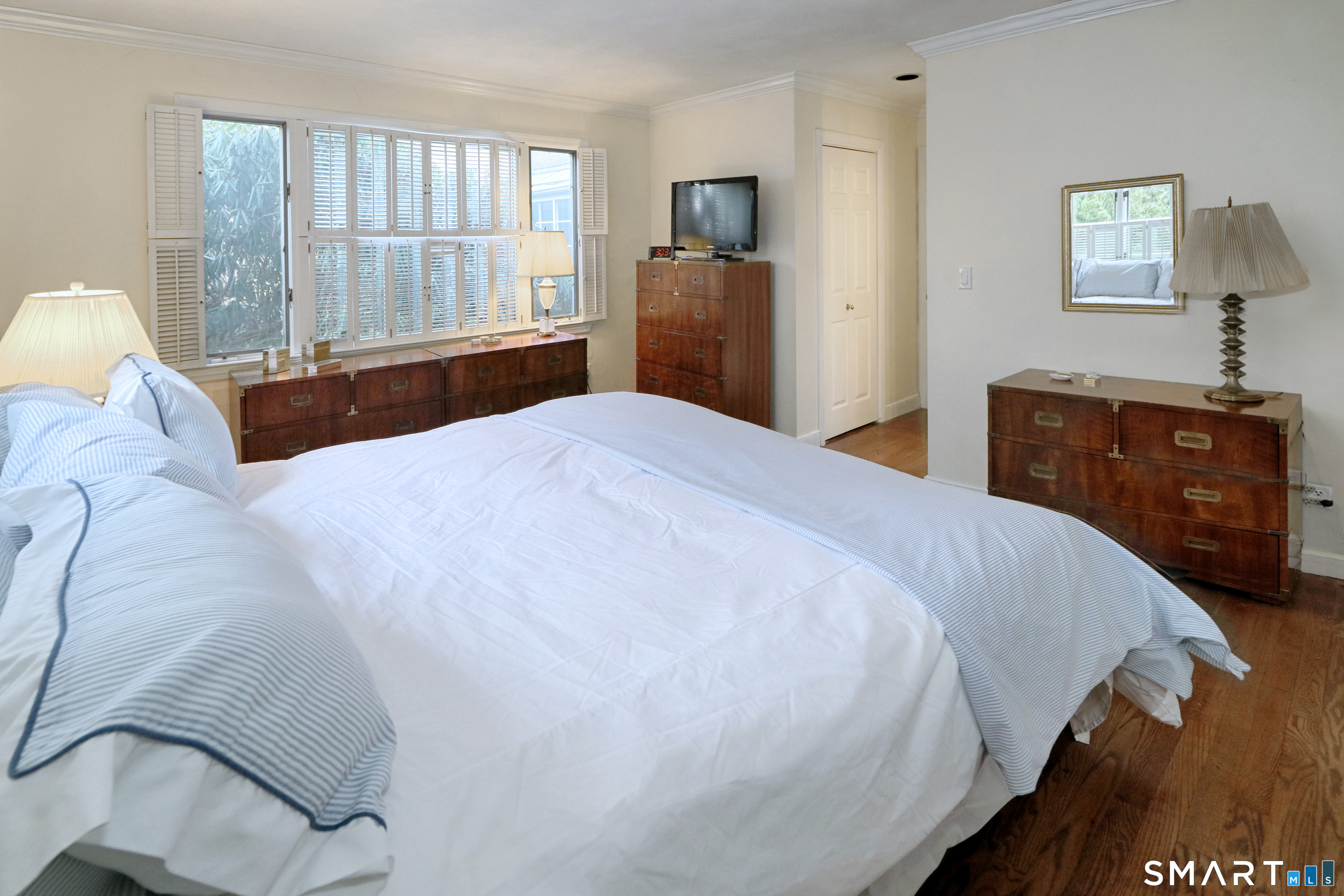 5 Over Rock Lane Westport, CT 06880 - Photo 15 of 28 Alternate view of primary bedroom with numerous windows and hardwood floor.