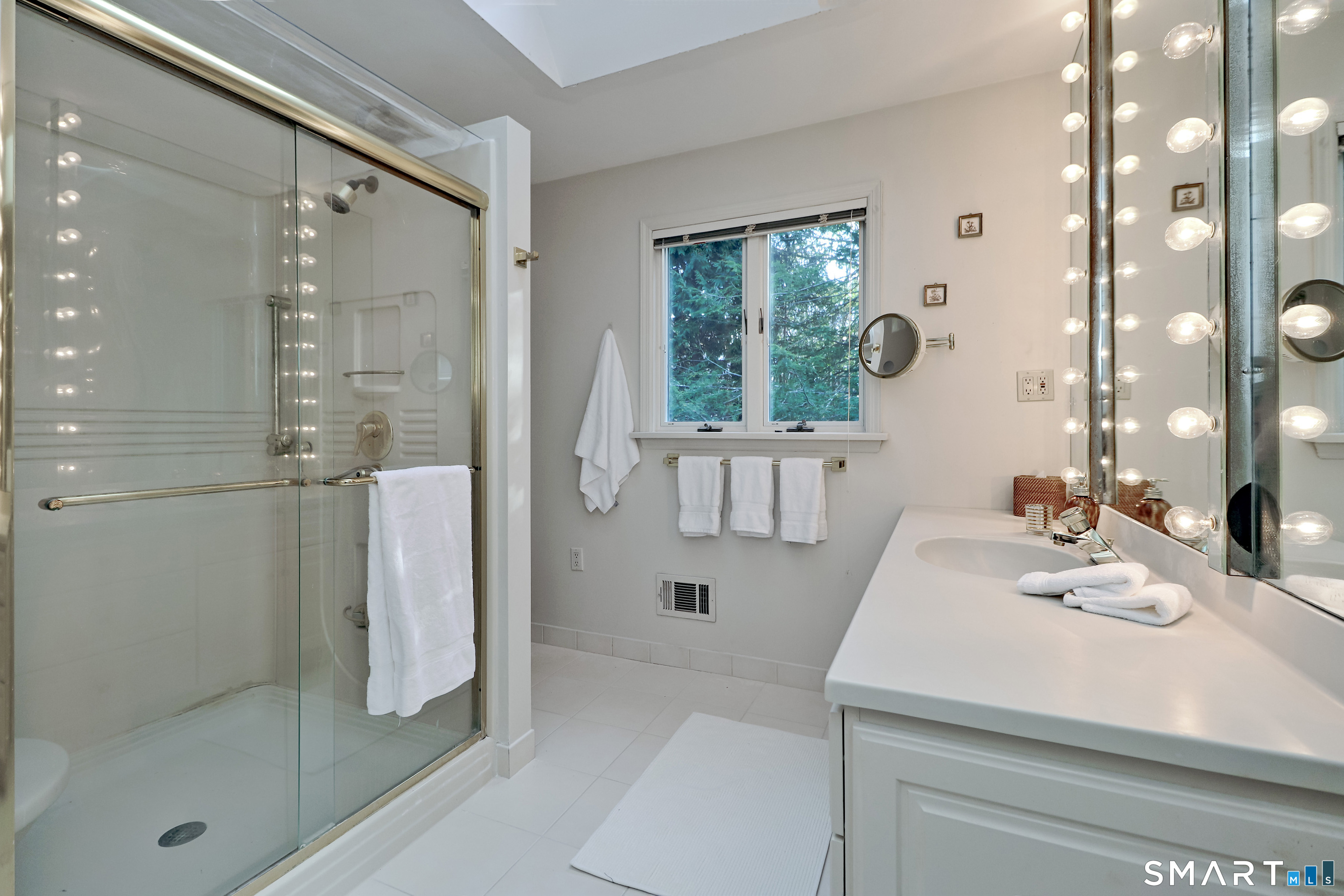 5 Over Rock Lane Westport, CT 06880 - Photo 16 of 28 Sunny, full bath in primary suite boasts skylights, large shower with seat and tile floor.