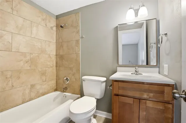 a bathroom with a sink toilet vanity and shower