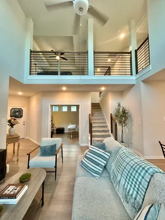 a living room with furniture and a lamp