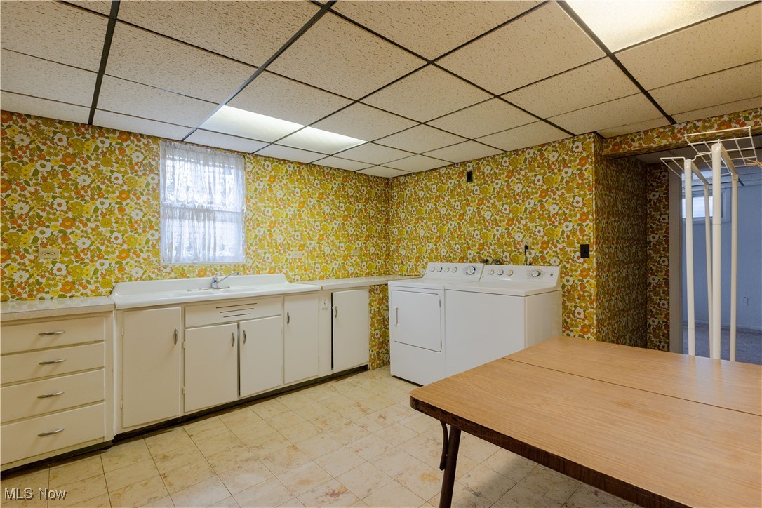1639 South Ridge Road West Ashtabula, OH 44004 - Photo 36 of 44 Washroom featuring a sink, independent washer and dryer, wallpapered walls, cabinet space, and light floors