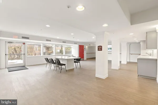 a view of a hall way with furniture and floor to ceiling window