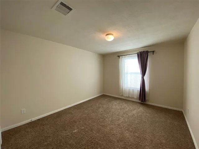 an empty room with a empty space and windows