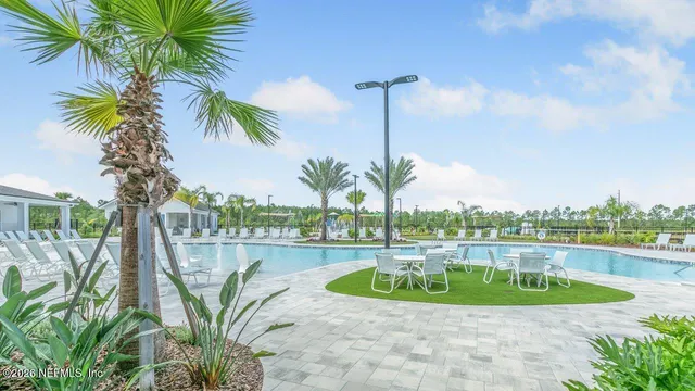 a view of swimming pool with outdoor seating and yard in back