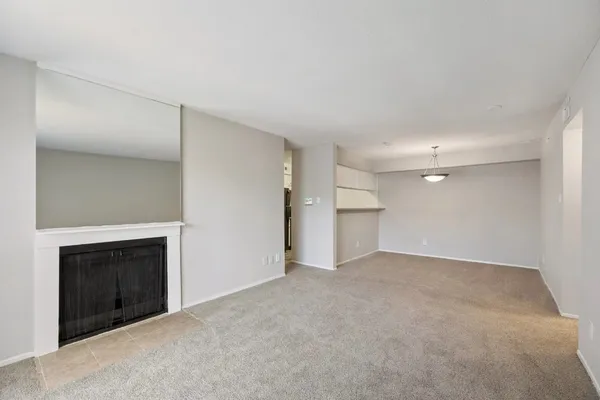 a view of an empty room with a fireplace