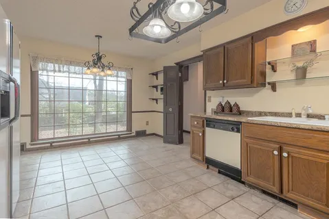a kitchen with stainless steel appliances granite countertop a stove a sink and a cabinets