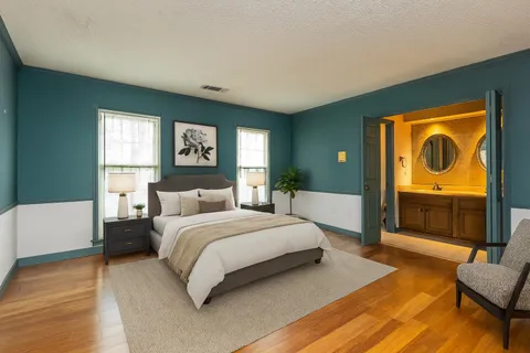 a spacious bedroom with a bed and a couch